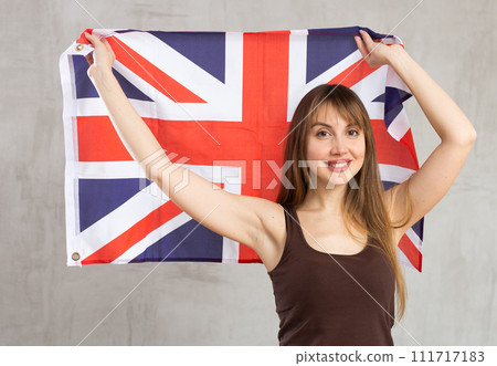 Young happy pretty woman displaying flag of united kingdom Young happy pretty woman displaying flag of united kingdom 111717183