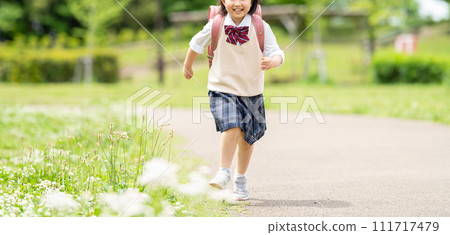 Smiling girl carrying a parcel 111717479