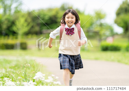 Smiling girl carrying a parcel 111717484