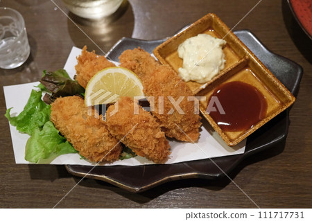Fried oysters with lemon 111717731