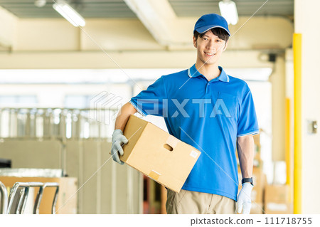Male driver working in a warehouse 111718755