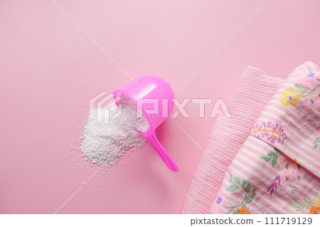 Washing powder in plastic spoon on blue background  111719129