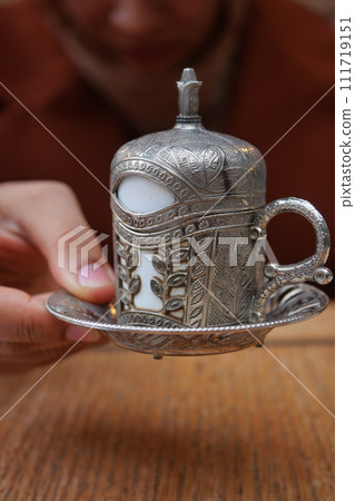 women holding a cup of turkish coffee  111719151
