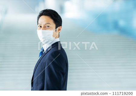 Image of a businessman in his thirties wearing a mask 111719200