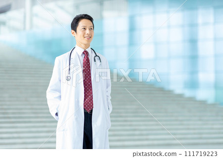 Male doctor wearing white coat Male doctor wearing white coat 111719223