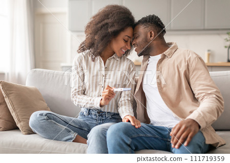 Joyful African Husband And Wife Celebrating Positive Pregnancy Test Indoor 111719359