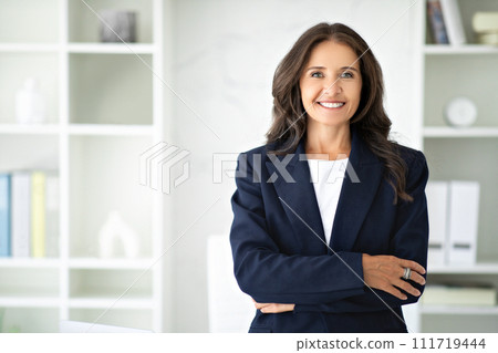 Confident mature woman posing in modern office Confident mature woman posing in modern office 111719444