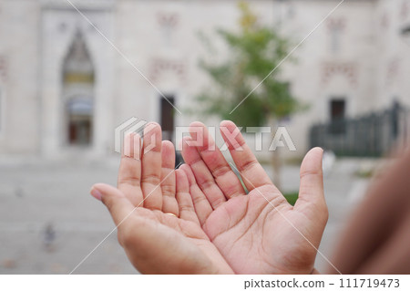 Muslim young woman in hijab is praying in mosque. 111719473