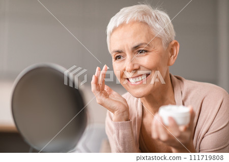 Gorgeous Mature Woman Applying Facial Moisturizer Preventing Wrinkles At Home Gorgeous Mature Woman Applying Facial Moisturizer Preventing Wrinkles At Home 111719808