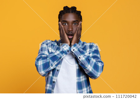 Portrait Of Shocked Black Young Man Opening Mouth And Touching Face Portrait Of Shocked Black Young Man Opening Mouth And Touching Face 111720042