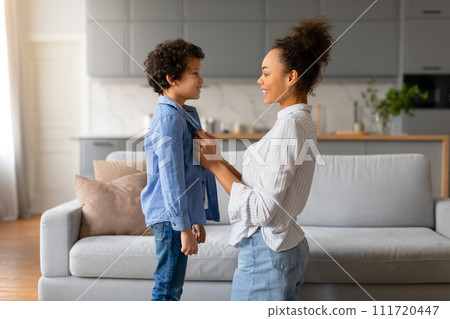 Black mother and son sharing moment, with loving eye contact 111720447