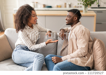 Cheerful Black Young Spouses Talking Enjoying Their Conversation At Home 111720527