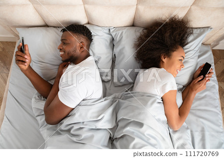 Cheating Black Husband And Wife Using Smartphones Lying In Bedroom 111720769