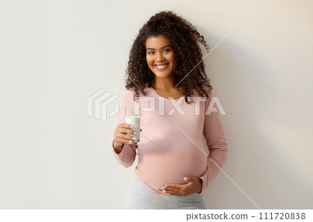 Pregnancy Nutrition. Portrait Of Black Smiling Pregnant Woman With Glass Of Milk Pregnancy Nutrition. Portrait Of Black Smiling Pregnant Woman With Glass Of Milk 111720838