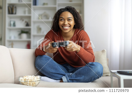 Domestic Fun. Cheerful Young Black Woman Playing Video Games At Home 111720970