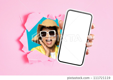 asian woman showing smartphone mockup screen through ripped pink paper asian woman showing smartphone mockup screen through ripped pink paper 111721119