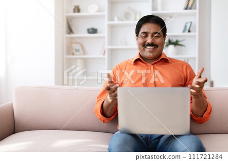 Positive middle aged eastern man have video call on laptop 111721284