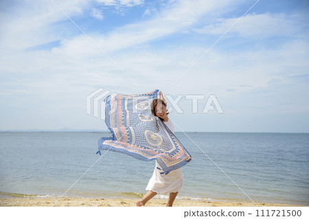 Cheerful asian woman barefoot walking on tropical summer beach. Woman walking along wave of sea water and sand on the beach. Enjoyment barefoot walk outdoor with freedom. Relaxation Travel Concept. Cheerful asian woman barefoot walking on tropical summer beach. Woman walking along wave of sea water and sand on the beach. Enjoyment barefoot walk outdoor with freedom. Relaxation Travel Concept. 111721500