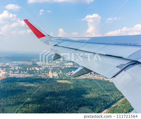 View from the airplane window during taking off on a clear summer morning View from the airplane window during taking off on a clear summer morning 111721564