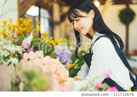 Female staff at a flower shop Female staff at a flower shop 111722678