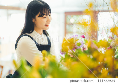 Female staff at a flower shop Female staff at a flower shop 111722685