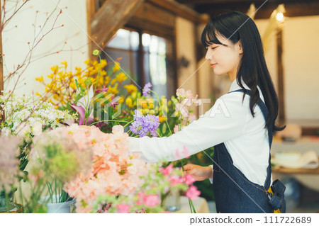 Female staff at a flower shop 111722689