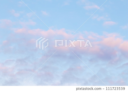 Background of blue sky with pale pink clouds in sunset Background of blue sky with pale pink clouds in sunset 111723539