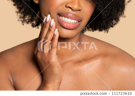 Black woman with toothache holding jaw, feeling discomfort 111723610