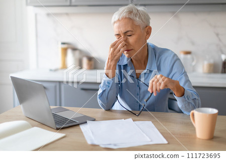 Senior Woman Having Sore Eyes And Migraine After Computer Indoor Senior Woman Having Sore Eyes And Migraine After Computer Indoor 111723695