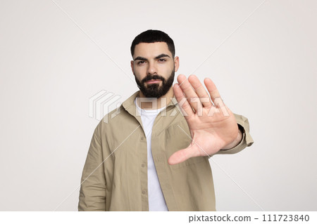 Sad confident attractive young latin guy with beard in casual make hand stop gesture 111723840
