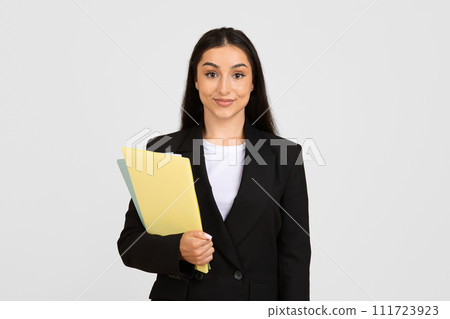 Confident young businesswoman with folders Confident young businesswoman with folders 111723923
