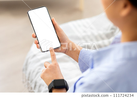Over shoulder view woman using phone with white screen Over shoulder view woman using phone with white screen 111724234