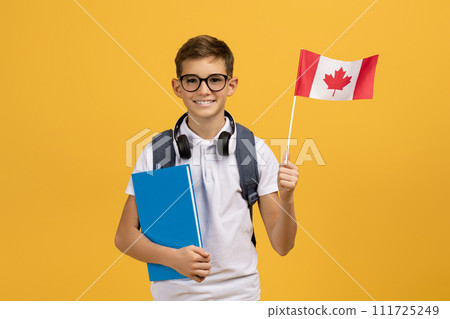 International Education. Happy Teen Boy With Backpack Holding Canadian Flag And Workbooks 111725249