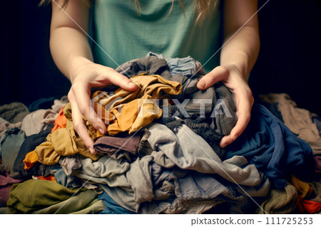 hands woman hold A pile of clothes next to a washing machine. Generative Ai 111725253