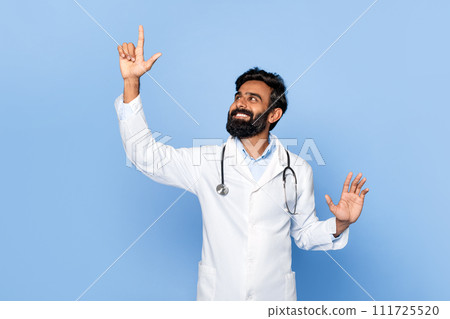Male doctor touching invisible screen with happy look Male doctor touching invisible screen with happy look 111725520