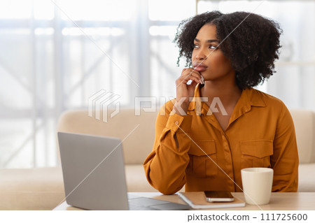 Concentrated pensive millennial curly black lady student manager with computer think 111725600