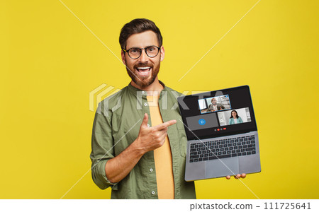 A cheerful man with glasses and a beard excitedly points to a laptop screen displaying 111725641
