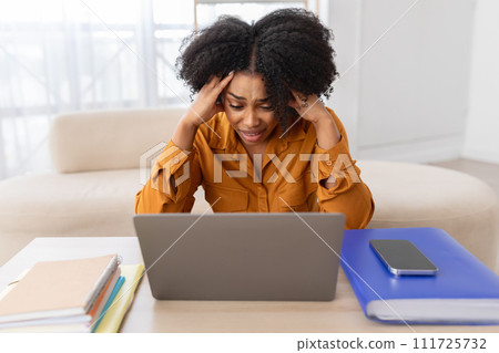 Unhappy despaired young curly african american woman student manager has stress with computer 111725732