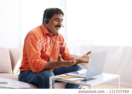 Middle aged indian man attending online webinar from home 111725769