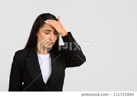 Stressed businesswoman with hand on forehead in despair Stressed businesswoman with hand on forehead in despair 111725884