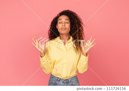 Calm black woman meditating on pink background 111726156