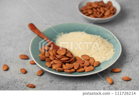 Fresh almond flour in a  bowl and almonds 111726214