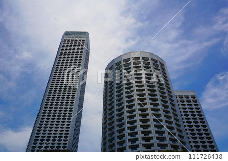 High-rise apartment building rising against a blue sky with clouds High-rise apartment building rising against a blue sky with clouds 111726438