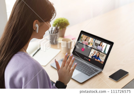 Young woman teacher waving at laptop screen 111726575