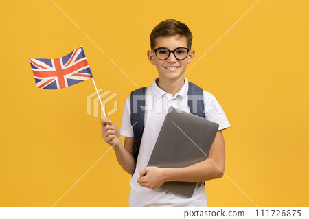 Study Abroad. Smiling Schoolboy In Eyeglasses Holding Laptop And British Flag 111726875