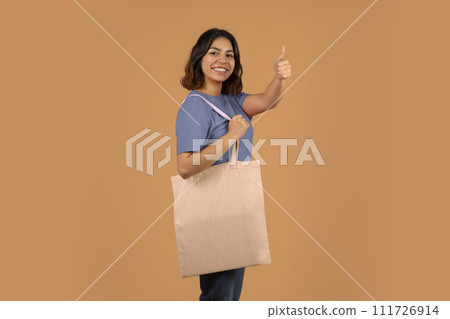 Cheerful young middle eastern woman with shopping bag Cheerful young middle eastern woman with shopping bag 111726914