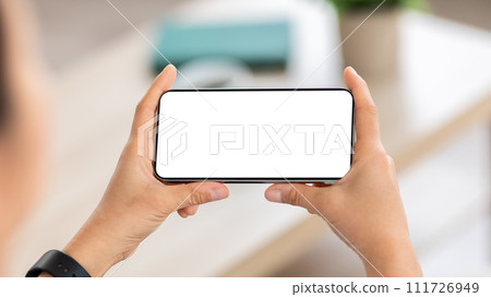 Smartphone with white blank screen in woman hands Smartphone with white blank screen in woman hands 111726949