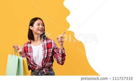 Excited korean woman holding shopping bags pointing at bubble, collage Excited korean woman holding shopping bags pointing at bubble, collage 111727310