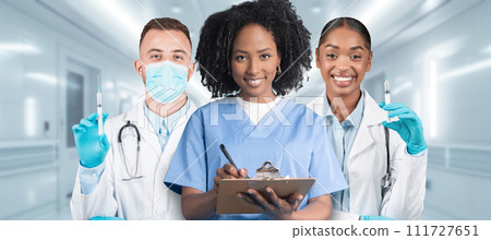 A diverse trio of medical professionals with a male doctor holding a syringe A diverse trio of medical professionals with a male doctor holding a syringe 111727651