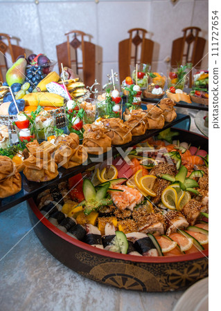 Delectable buffet spread of seafood, sushi, salads, fruit, and pastries. Delectable buffet spread of seafood, sushi, salads, fruit, and pastries. 111727654